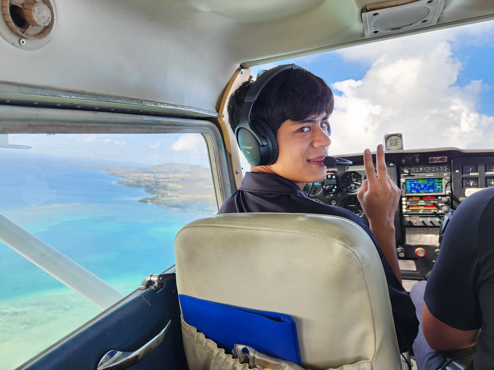 Jaden Goode in cockpit over turquoise ocean