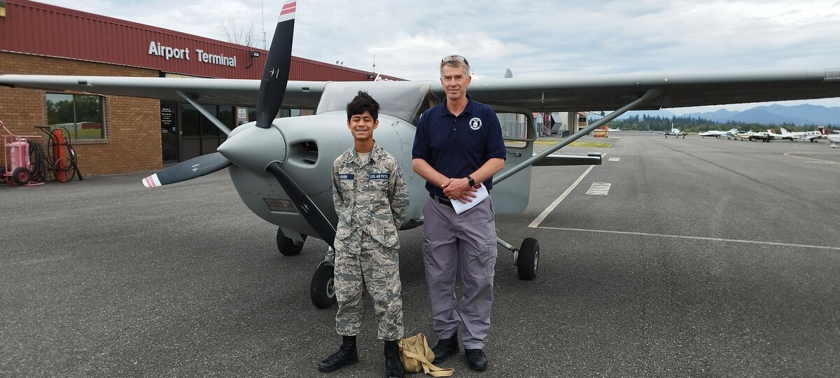 Jaden in CAP uniform at airport with Cessna