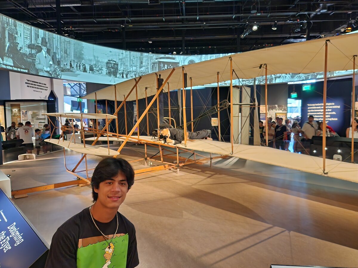 Jaden at air museum in front of Wright Brothers exhibit